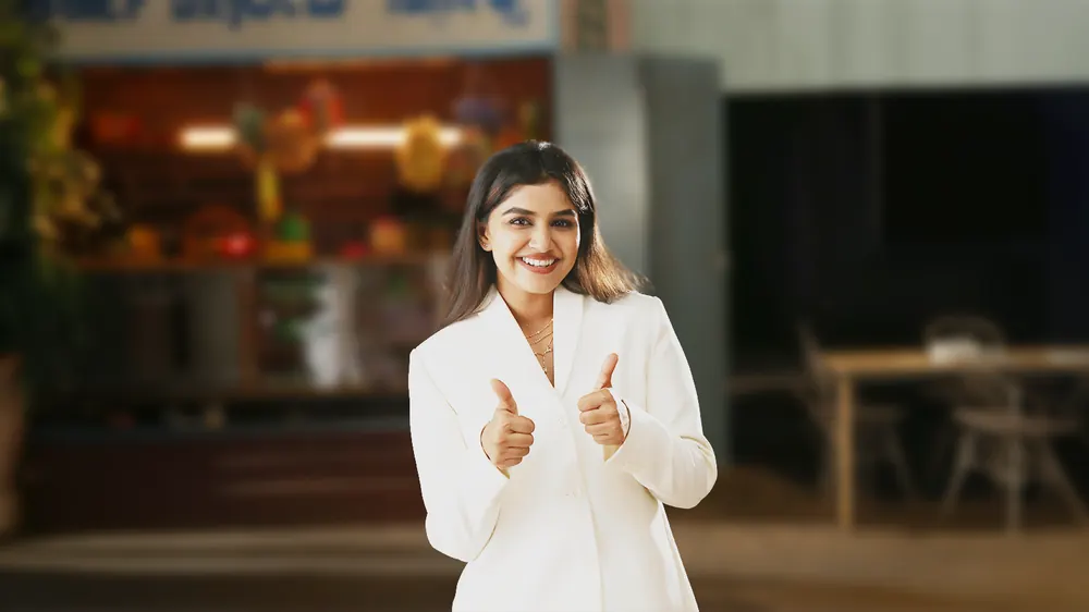 Woman giving thumbs up and smiling