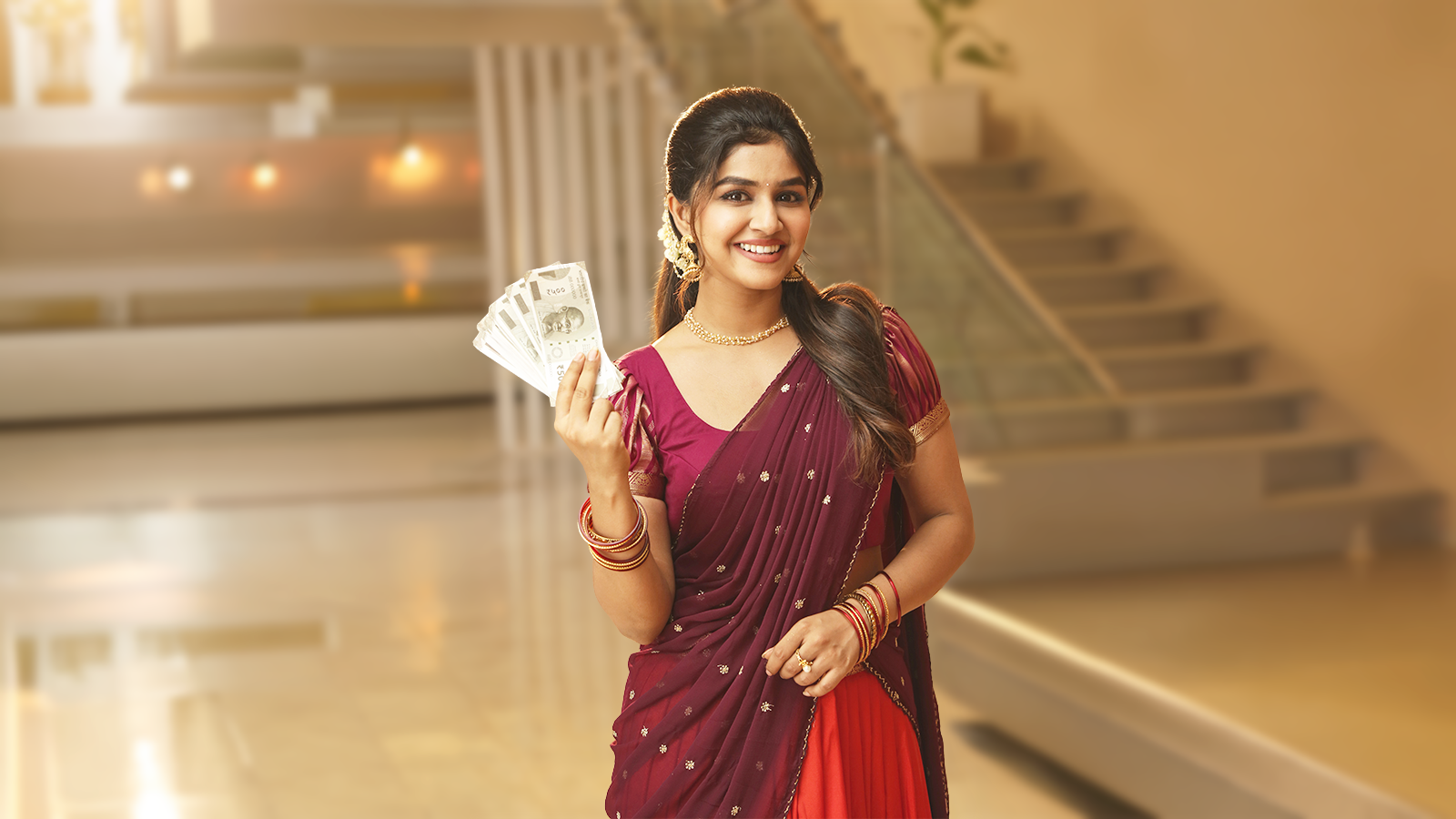 Woman holding cash after selling gold jewellery at G1 Gold in Bangalore