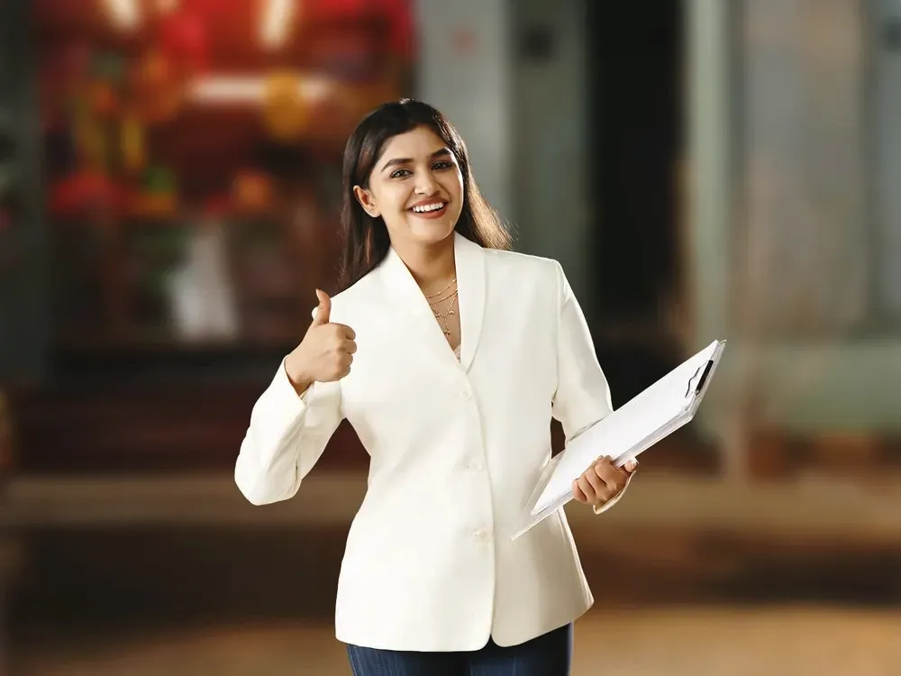 Woman holding a clipboard giving a thumbs-up